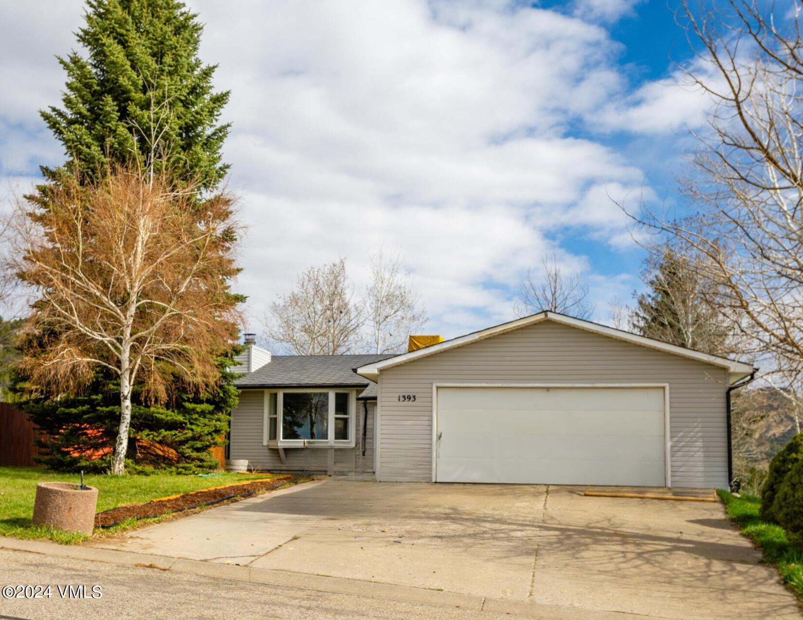 1393 Ridge Road Meeker, CO 81641 - Photo 2 of 4 a front view of a house with a yard and garage