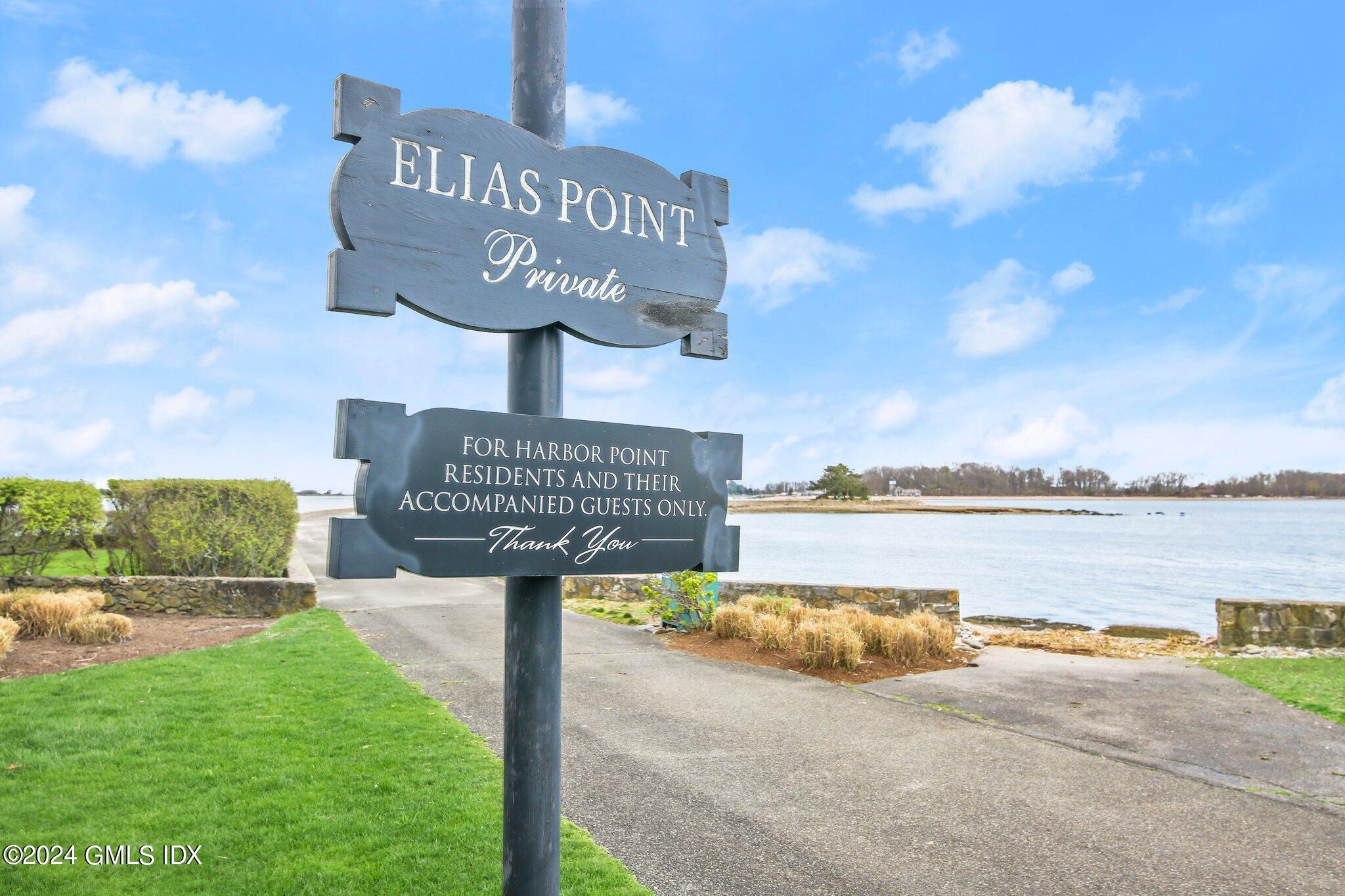 1 Seagate Road Riverside, CT 06878 - Photo 11 of 16 a street sign on a wall next to a lake