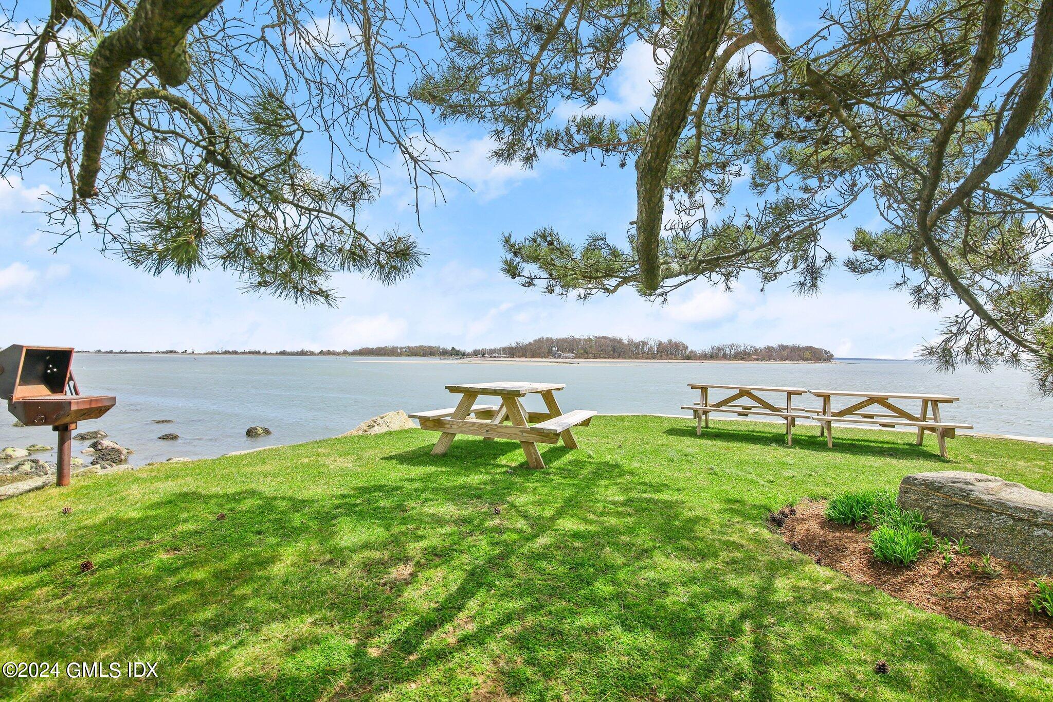 1 Seagate Road Riverside, CT 06878 - Photo 14 of 16 a backyard of a house with lots of green space and lake view