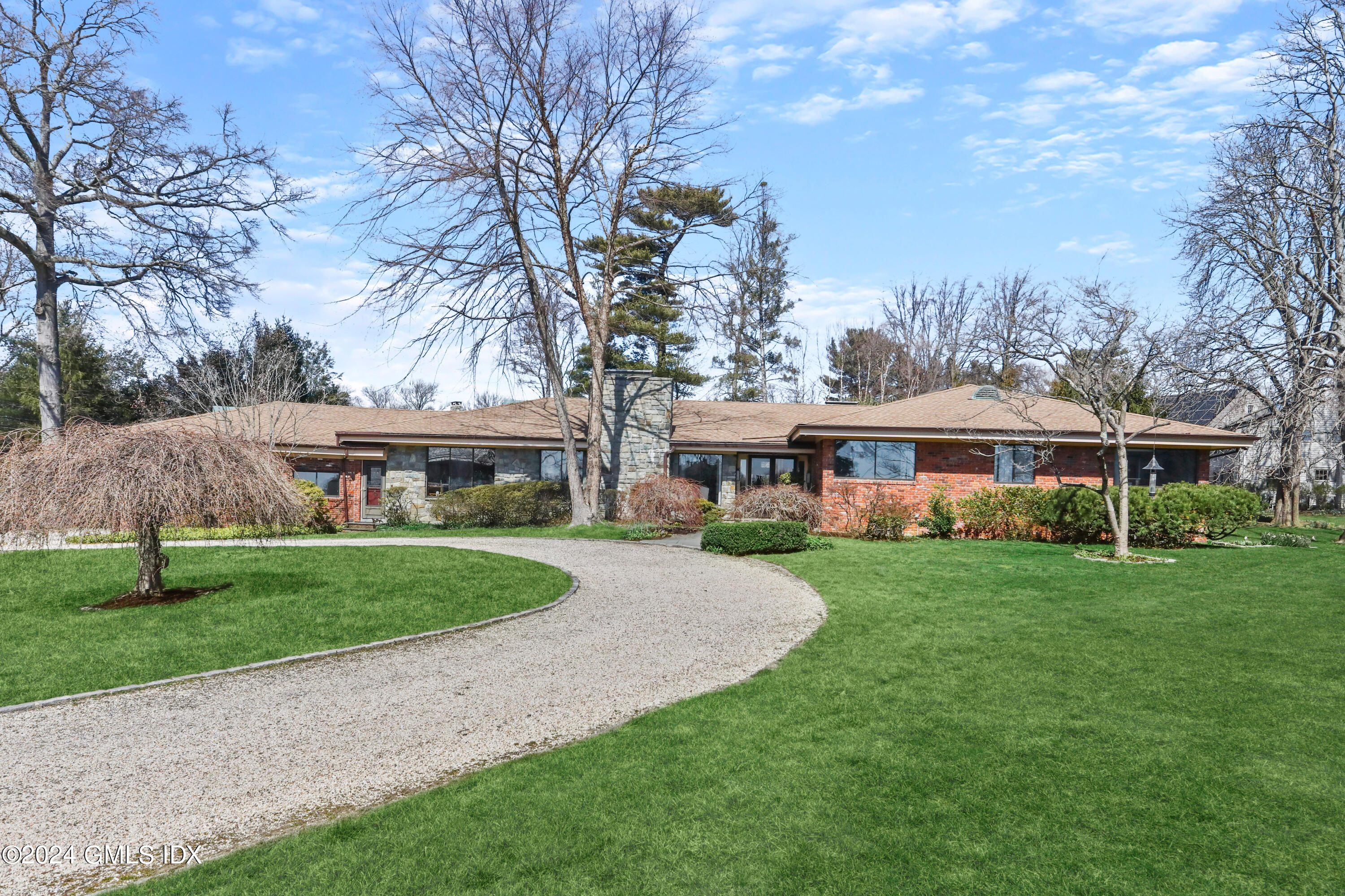 1 Seagate Road Riverside, CT 06878 - Photo 3 of 16 a view of a big house with a big yard and large trees