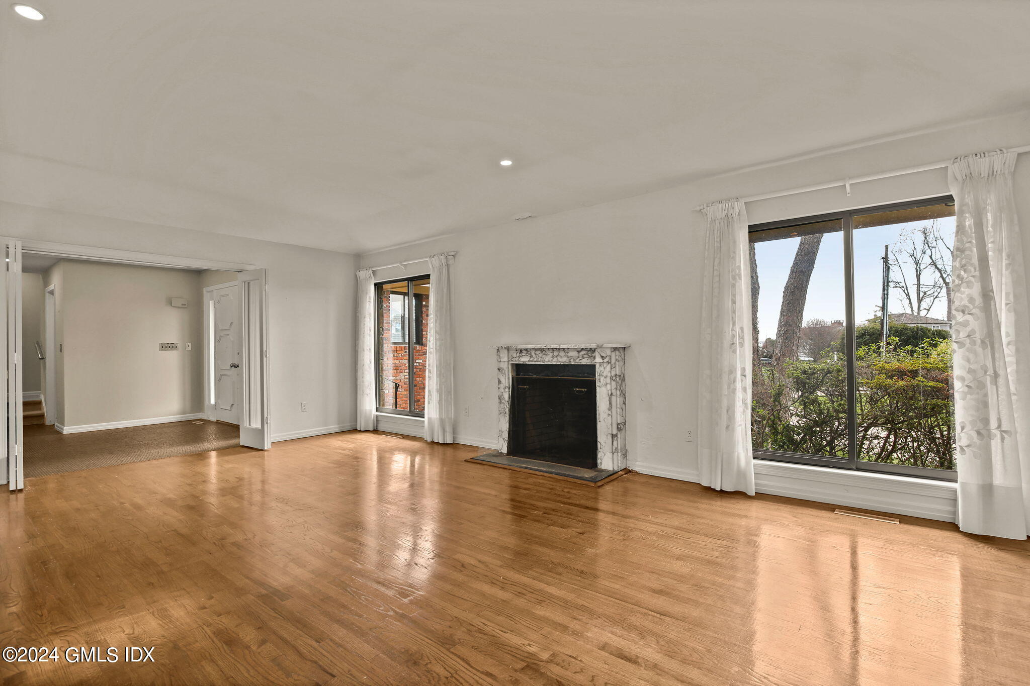 1 Seagate Road Riverside, CT 06878 - Photo 5 of 16 a view of an empty room with wooden floor and a window