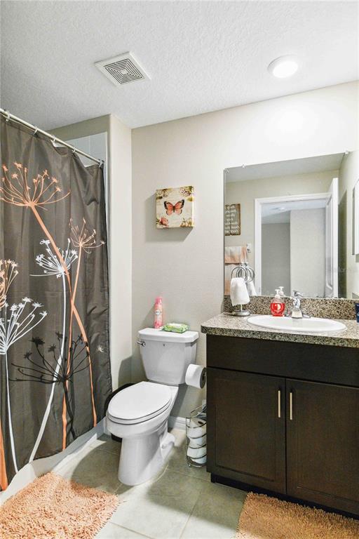 14339 Easy Goer Street Ruskin, FL 33573 - Photo 34 of 49 a bathroom with a toilet sink and mirror