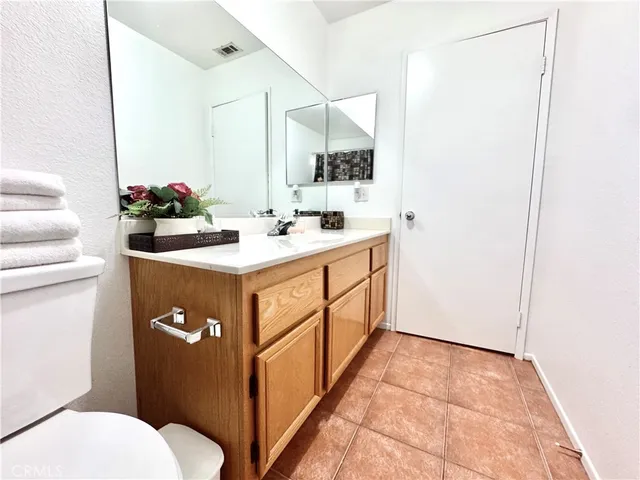 a bathroom with a sink toilet and mirror