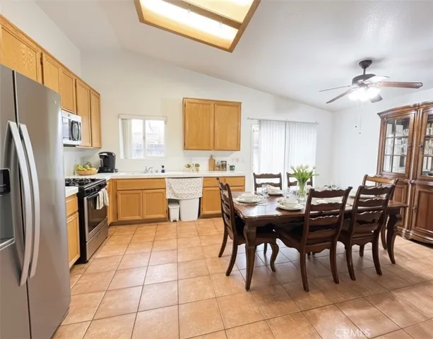 a kitchen with a table chairs and refrigerator