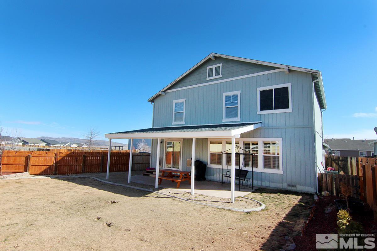 8951 Kemmer Street Reno, NV 89506 - Photo 12 of 12 a house with trees in the background