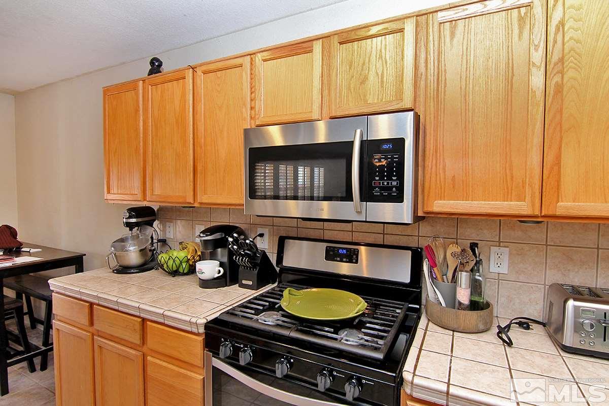 8951 Kemmer Street Reno, NV 89506 - Photo 4 of 12 a kitchen with a stove and a sink
