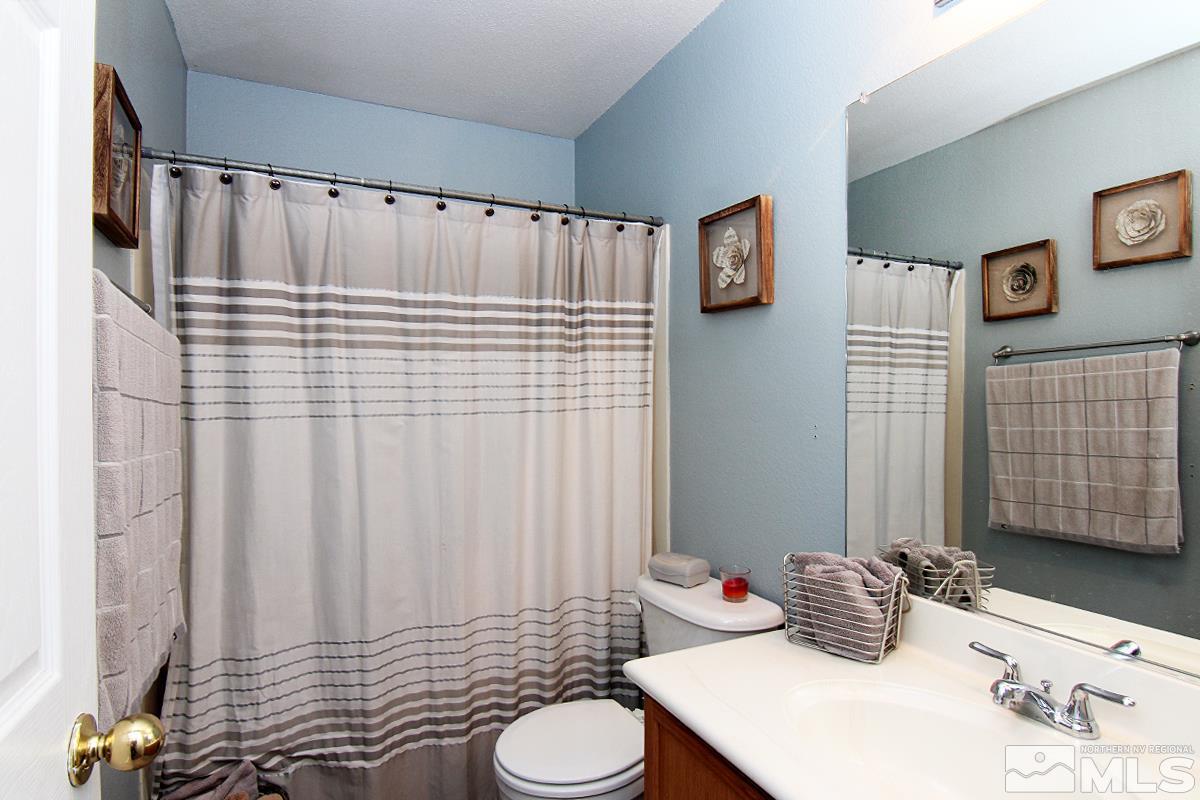 8951 Kemmer Street Reno, NV 89506 - Photo 9 of 12 a bathroom with a sink toilet and shower