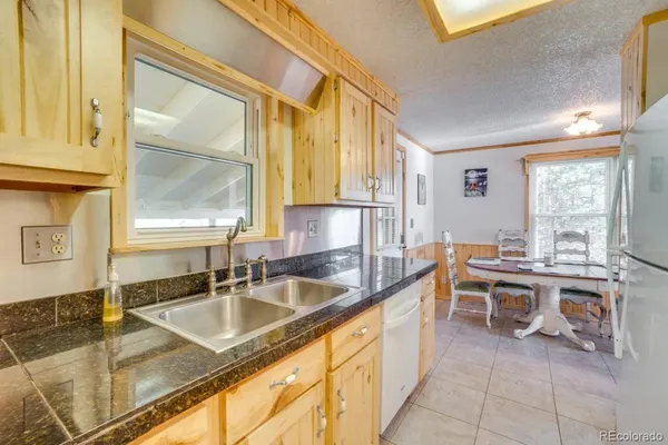 a large kitchen with kitchen island a large window in it