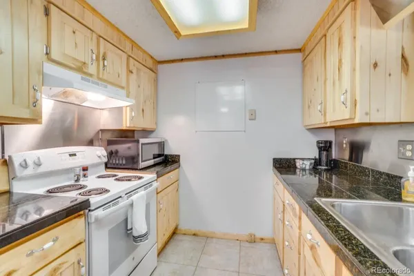 a kitchen that has a sink and a stove