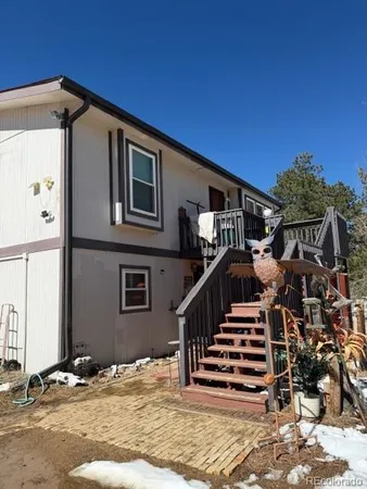 a view of a house with wooden fence