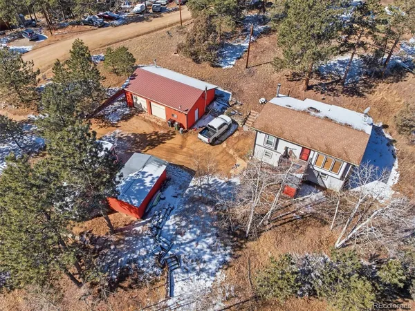 an aerial view of a house with a yard