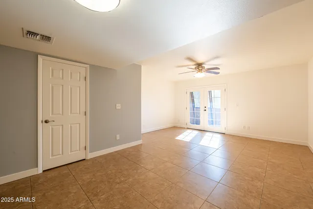 a view of a livingroom with a ceiling fan and window