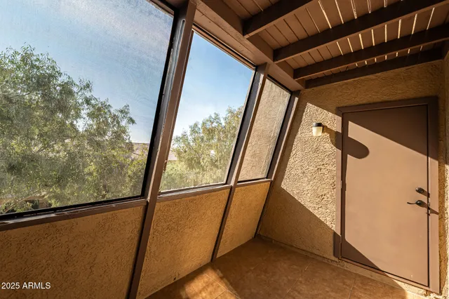 a view of a hallway with wooden floor and a living room
