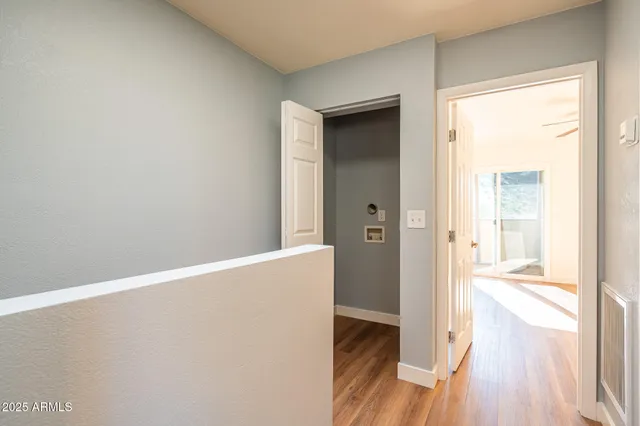 a view of empty room with wooden floor