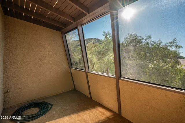 a view of a room with wooden floor and window
