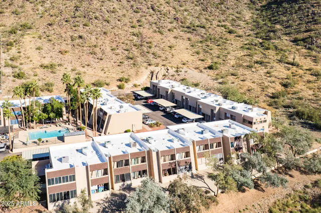 a view of a large mountain with a mountain in the background