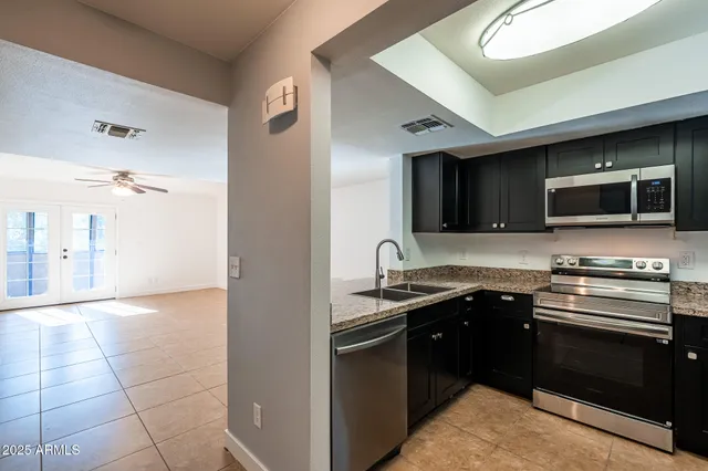 a kitchen with a sink stainless steel appliances and cabinets