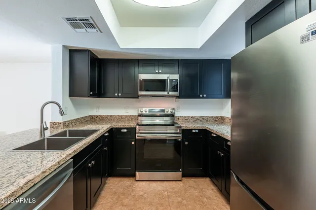 a kitchen with a sink stove and cabinets