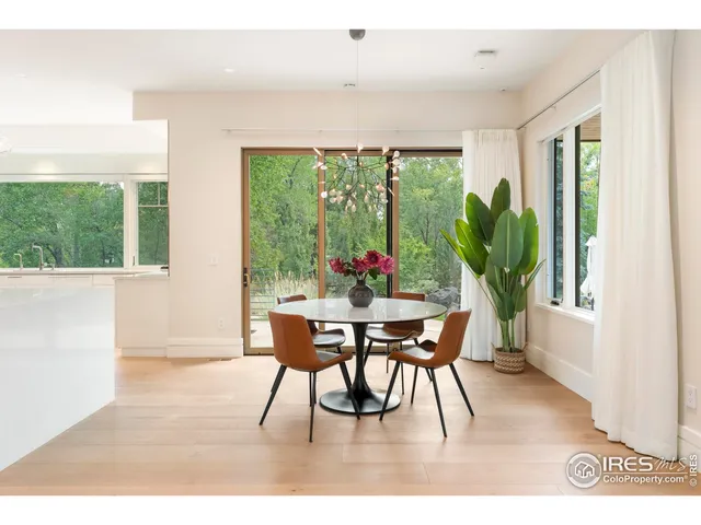 a dining room with furniture window and outside view