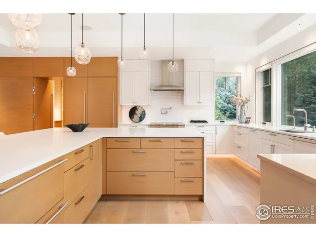 a kitchen with a sink window and cabinets