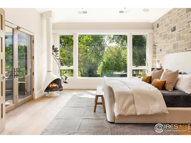 a bed sitting in a bedroom next to a large window