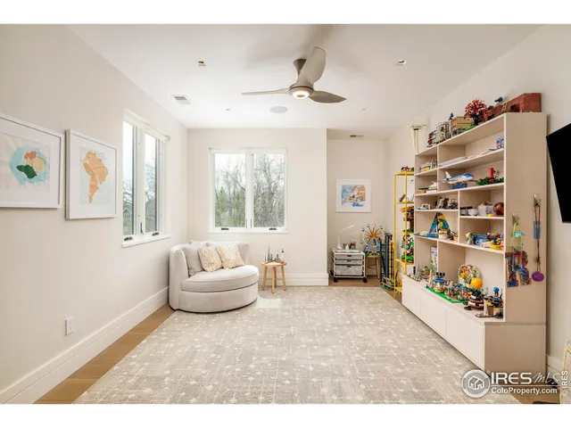 a bedroom with furniture and a large window