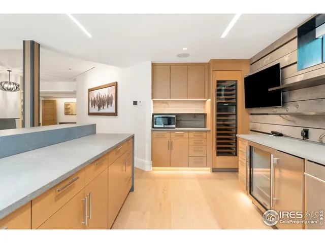 a kitchen with stainless steel appliances kitchen island granite countertop a stove a sink and a microwave