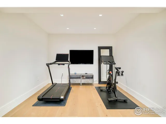 a living room with a flat screen tv and a view of kitchen