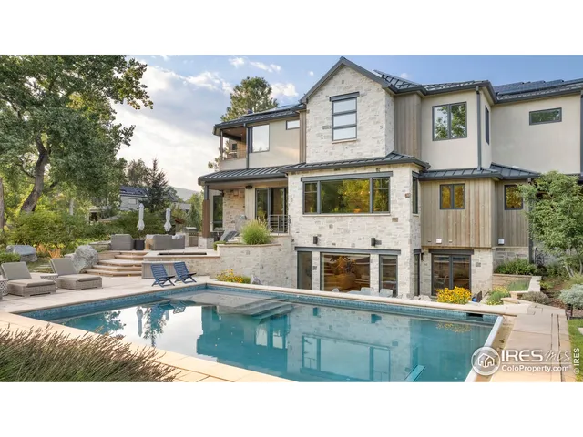 a swimming pool view with outdoor seating