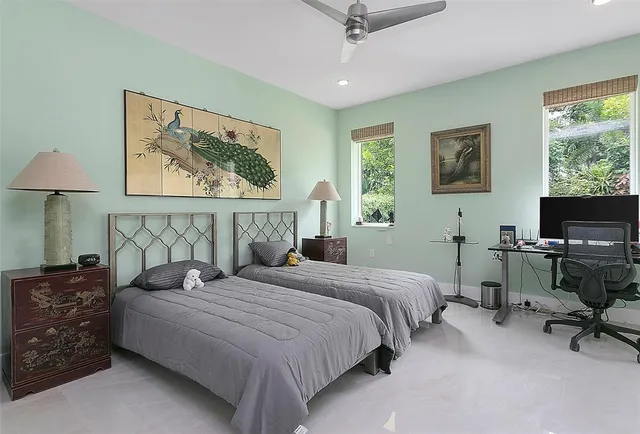 a bedroom with a bed a couch and a window