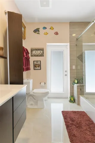 a living room with a couch and paintings on the wall