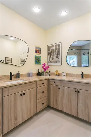 a spacious bathroom with a granite countertop sink mirror and a