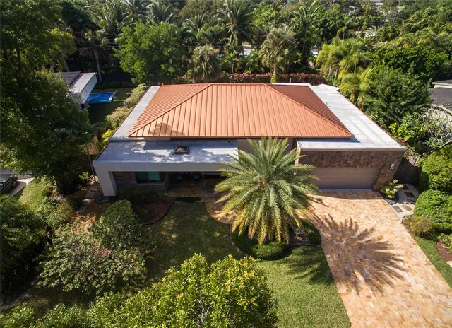 a backyard of a house with table and chairs
