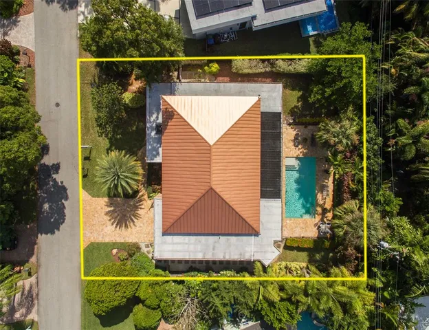 an aerial view of a house with a yard