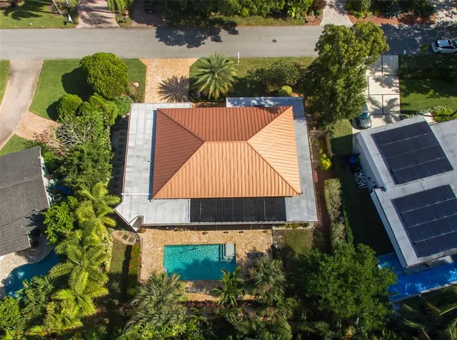 an aerial view of a house with swimming pool and garden