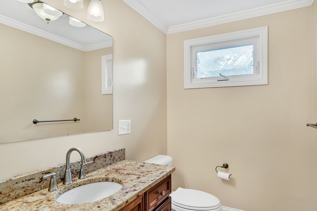 141 Renfrew Street Arlington, MA 02476 - Photo 12 of 41 a bathroom with a granite countertop sink and a mirror