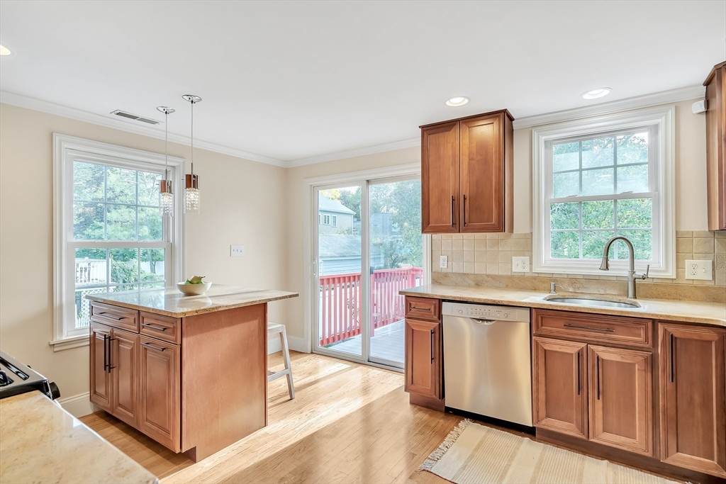 141 Renfrew Street Arlington, MA 02476 - Photo 13 of 41 a kitchen with granite countertop a sink stove and cabinets