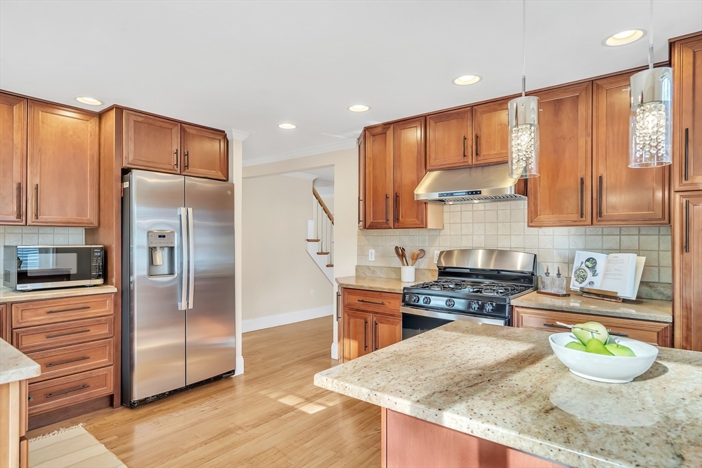 141 Renfrew Street Arlington, MA 02476 - Photo 15 of 41 a kitchen with stainless steel appliances granite countertop a refrigerator a stove and a sink