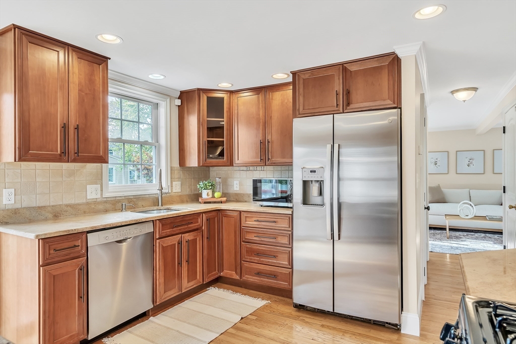 141 Renfrew Street Arlington, MA 02476 - Photo 18 of 41 a kitchen with a refrigerator sink and cabinets