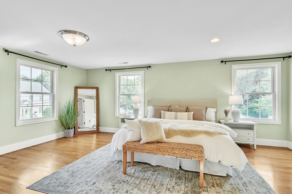 141 Renfrew Street Arlington, MA 02476 - Photo 20 of 41 a spacious bedroom with a bed a dresser and wooden floor
