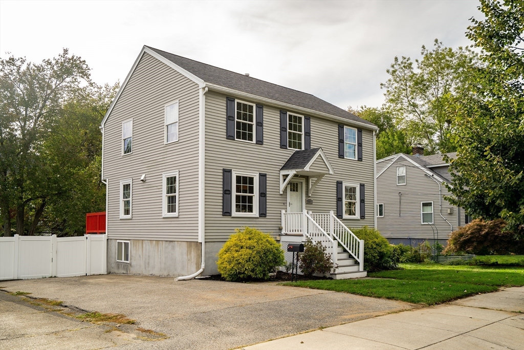 141 Renfrew Street Arlington, MA 02476 - Photo 2 of 41 a front view of a house with a garden