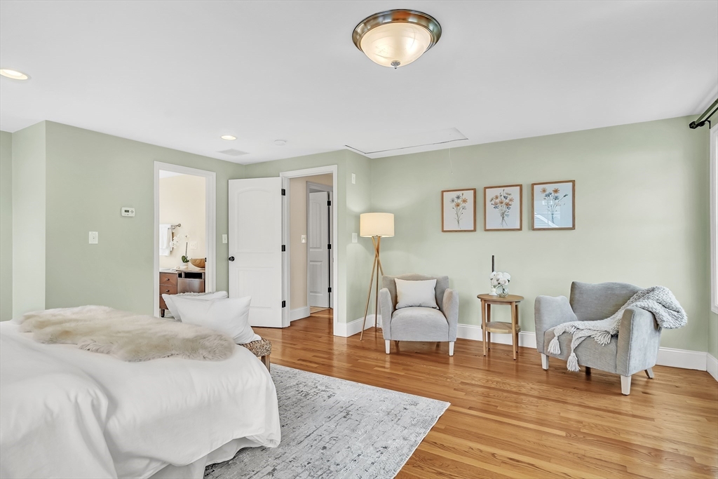 141 Renfrew Street Arlington, MA 02476 - Photo 22 of 41 a spacious bedroom with a bed a table and chair