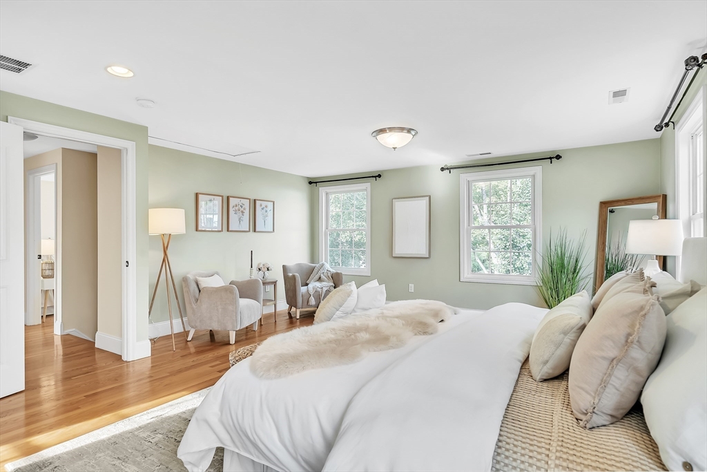 141 Renfrew Street Arlington, MA 02476 - Photo 23 of 41 a bedroom with a bed and wooden floor