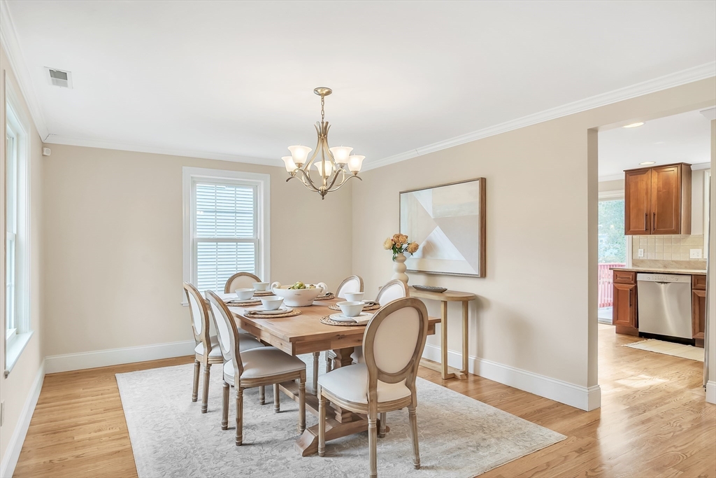 141 Renfrew Street Arlington, MA 02476 - Photo 3 of 41 a view of a dining room with furniture a chandelier and wooden floor