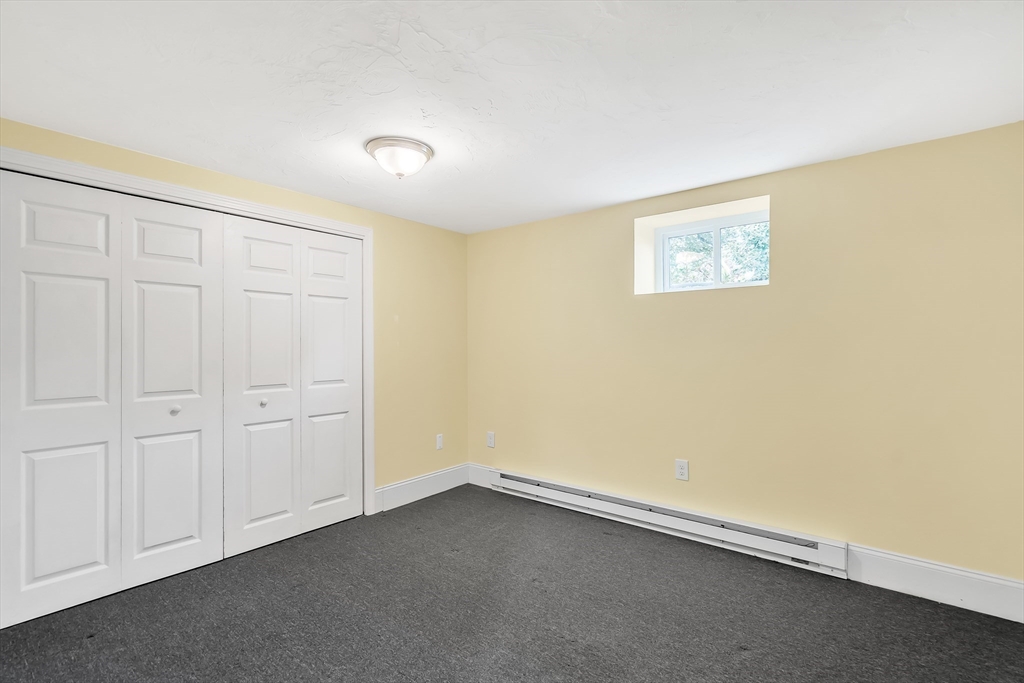 141 Renfrew Street Arlington, MA 02476 - Photo 33 of 41 an empty room with a bench