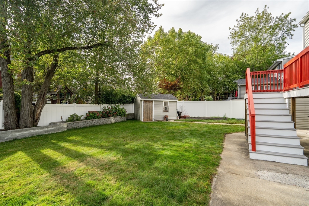 141 Renfrew Street Arlington, MA 02476 - Photo 39 of 41 a view of a back yard with a house and garden