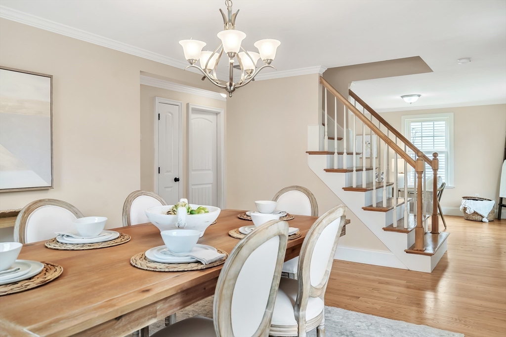 141 Renfrew Street Arlington, MA 02476 - Photo 6 of 41 a view of a dining room with furniture a chandelier and wooden floor