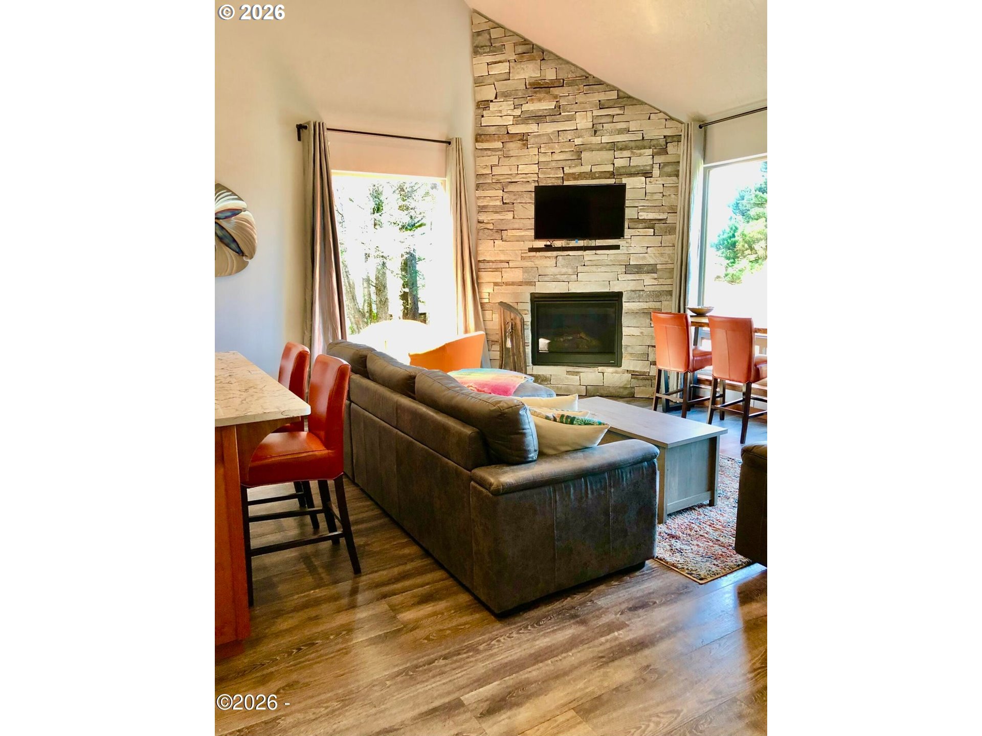 15 Shell Street Yachats, OR 97498 - Photo 11 of 47 a living room with furniture a flat screen tv and a fireplace