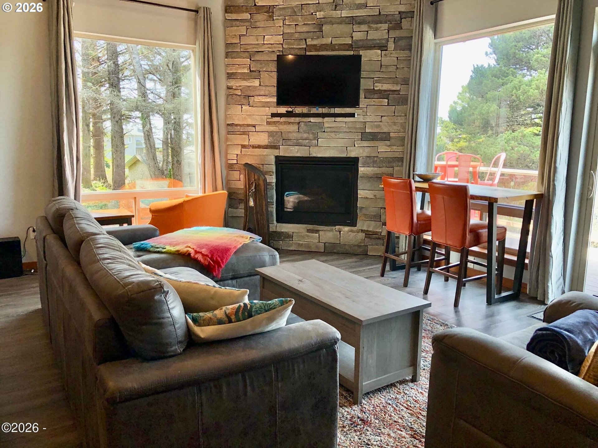 15 Shell Street Yachats, OR 97498 - Photo 12 of 47 a living room with furniture a fireplace and a flat screen tv