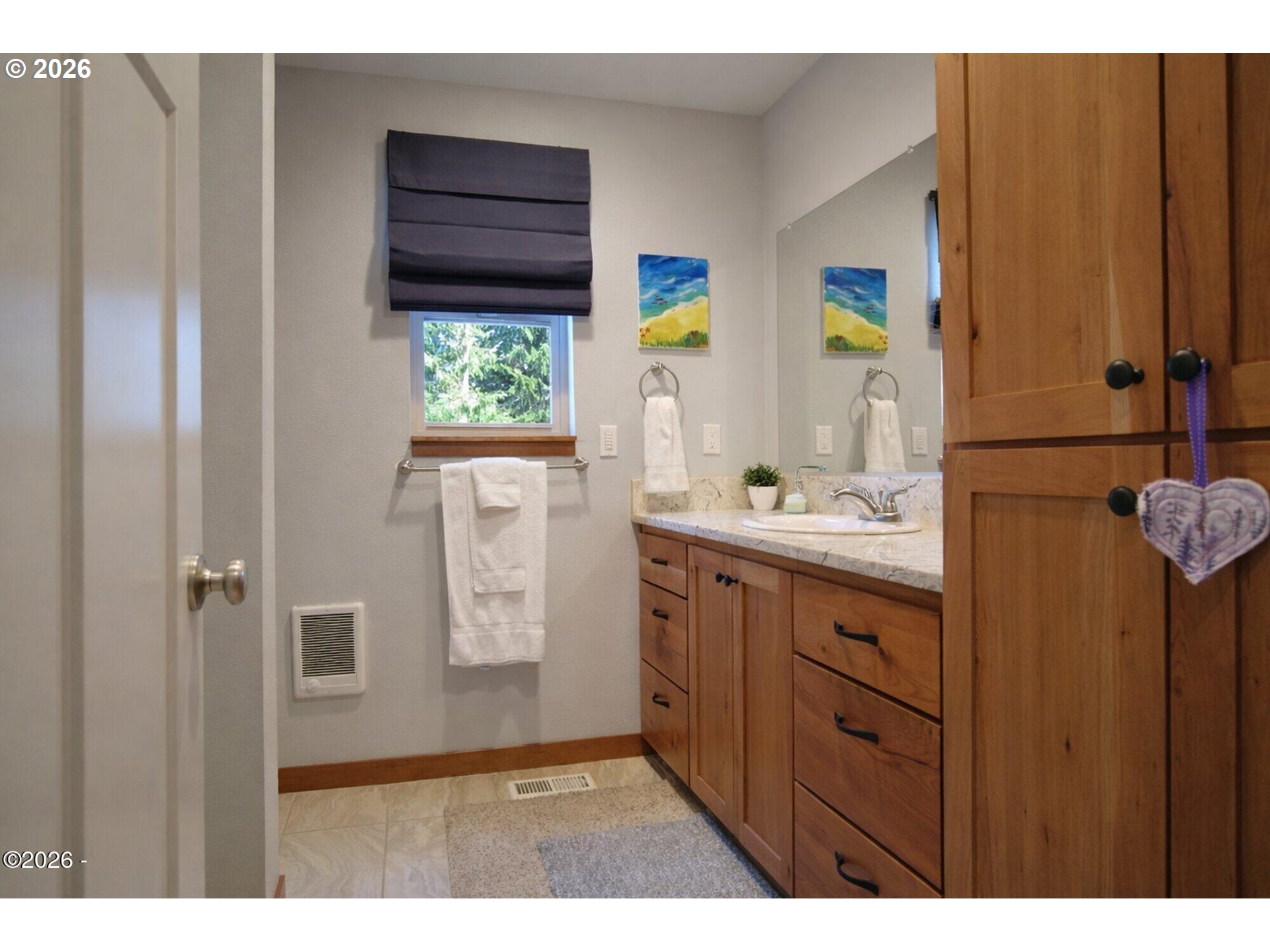 15 Shell Street Yachats, OR 97498 - Photo 34 of 47 a bathroom with a sink a mirror and a window
